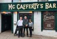 Pierce Brosnan posing for a picture with staff outside McCafferty's Bar in Donegal